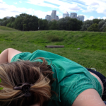 Me, sleeping in a field of clover with the City in the background