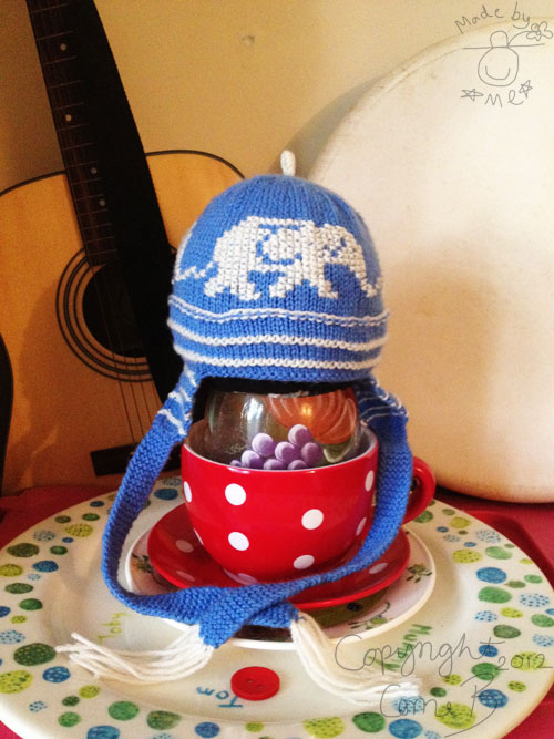 The baby hat from the side, modelled on a plant pot, vase and papier mache baby head. The baby hat from the side, modelled on a plant pot, vase and papier mache baby head.