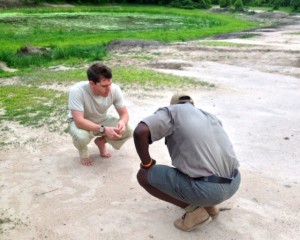 Guide and BRO drawing spoor in the sand.