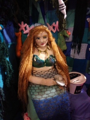 Gorgeous mermaid collecting donations.