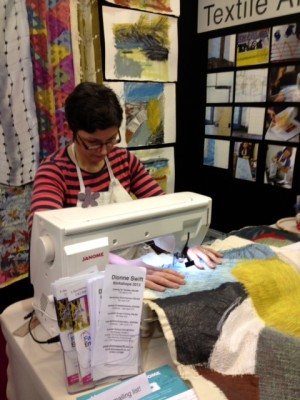 Machine embroidering on a stall.