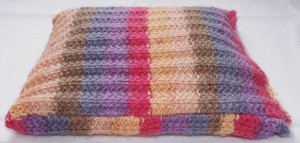 Stripy pencil case with popper closing.