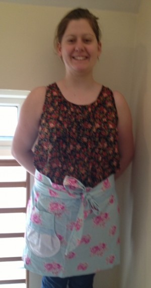 Modelling the flowery apron...slightly blurry and unflattering photo here, sorry about that!