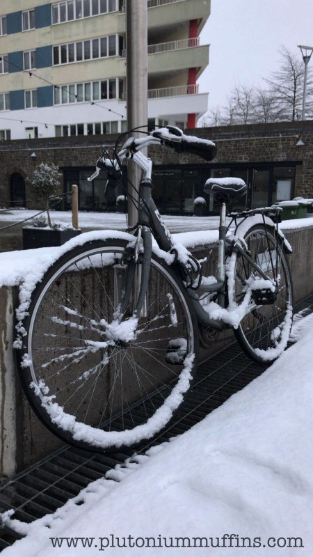 A frozen bike in the snow.