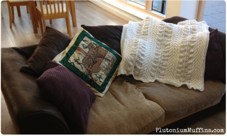 Full length shot of baby blanket on sofa for scale.