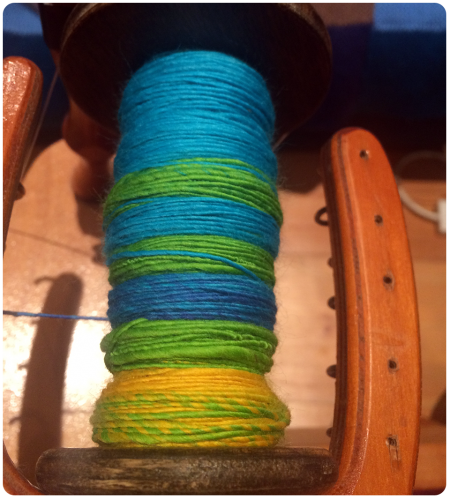 Spinning the merino into calming blue and green singles.