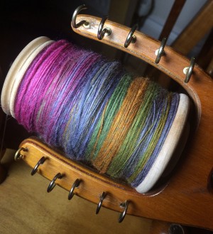 One very full bobbin of Dragon Yarn singles.