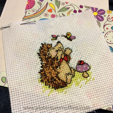 Stitching and outlining on a little cross stitch hedgehog completed.