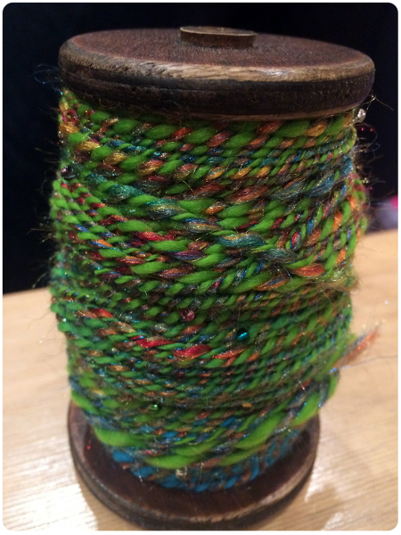 A bobbin full of the first yarn.