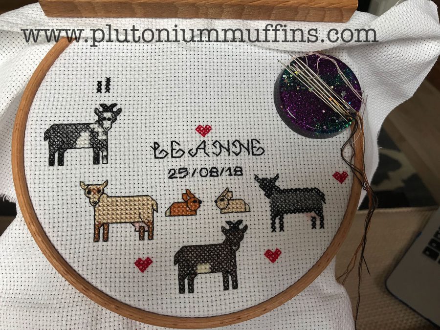 The sampler half done. The backstitch on the writing is done with two strands of floss, the backstitch on the animals using one strand.