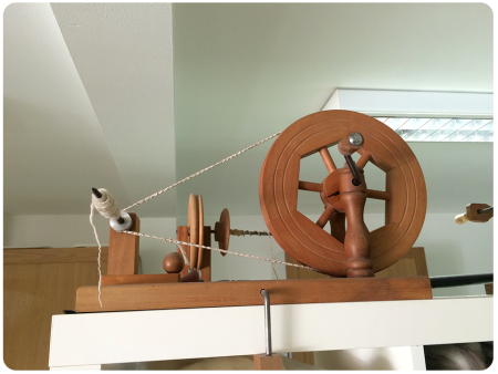 A hand-turned spinning wheel.