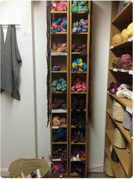 A bookcase full of handpainted yarns.