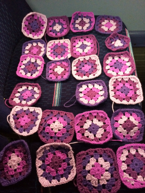 Laying out my Granny Squares while finishing the last two off.