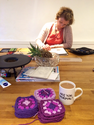 Wonder-Mum drawing with my pile of Granny Squares in front of her.