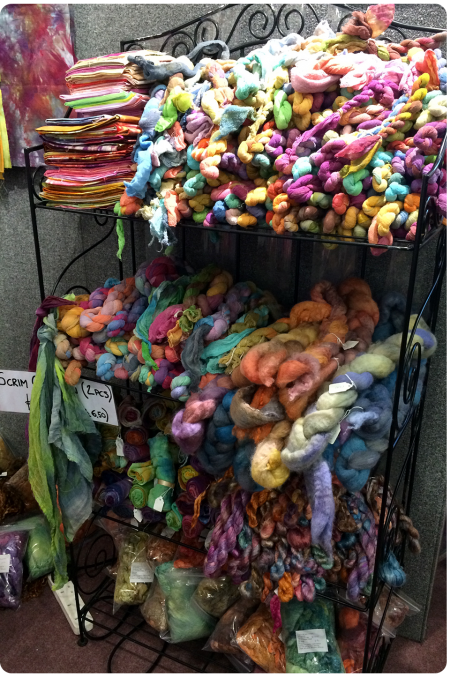 Stack of yarns and roving and felt and fabric...heaven.