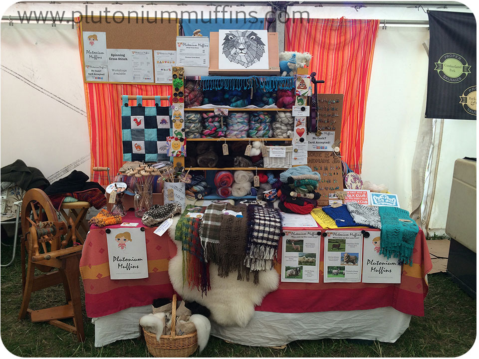 My stall at the festival where I taught stitching - look closely, you can see all the emoji cross stitch samples!