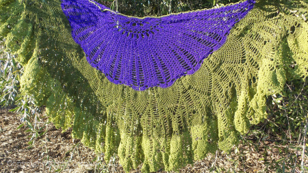 A beautiful purple and green shawl crocheted by Kristi Zemas.