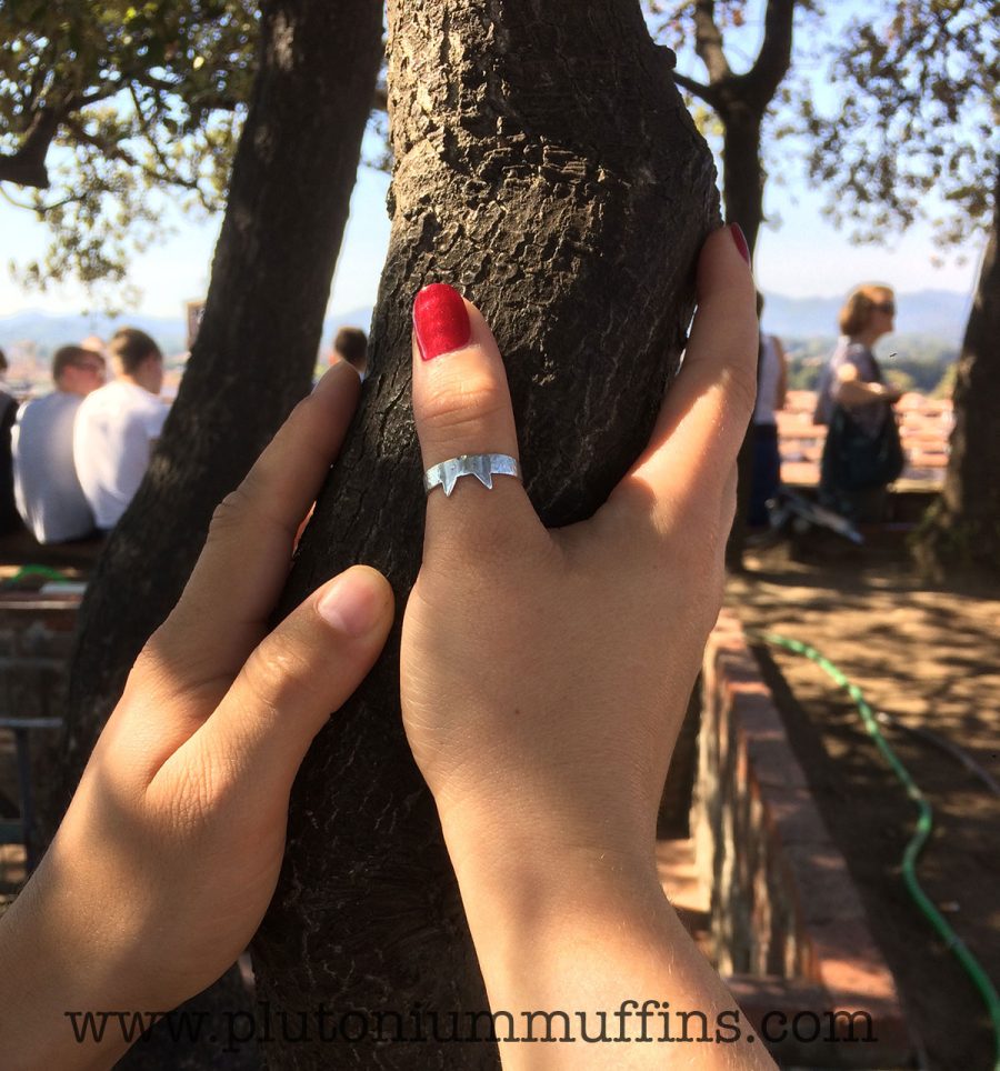 Clutching an ancient oak tree at the top of a tower in Italy. (The other hand is John's).