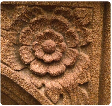 An English rose carved into a fireplace inside.