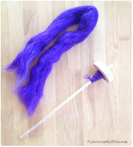 Spinning purple roving and mini spindle.