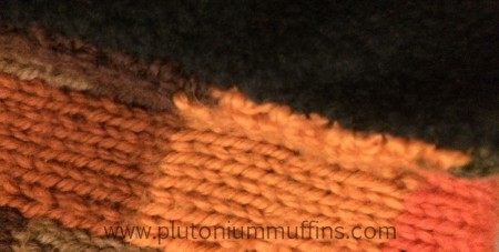 Close-up of stitches holding the fleece and knitting together.