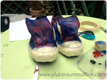 The masked shoes with an underlayer of paint, drying and ready to have stars put on them.