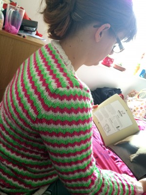 Sneaky "Corrie wearing Zigzag Jumper reading about sheep" photo. Thanks John!