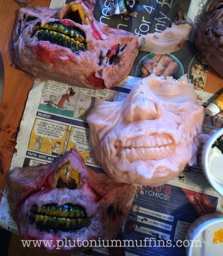 An unpainted zombie mask in the middle, with two painted top and bottom. Zombie invasion of the farm: ready!