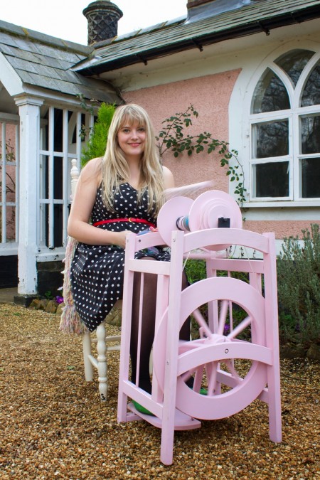 A gorgeous pink spinning wheel, with a smiling Louise in her throne.